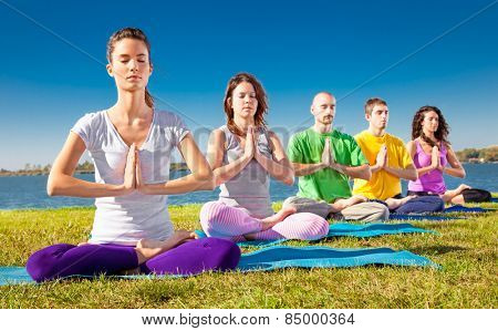 Group of young people have meditation on yoga class. Yoga concept.