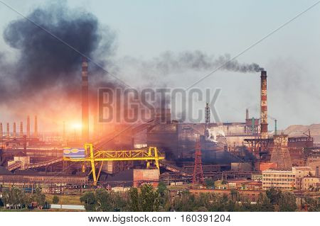 Metallurgy Plant In Ukraine At Sunset. Steel Factory With Smog