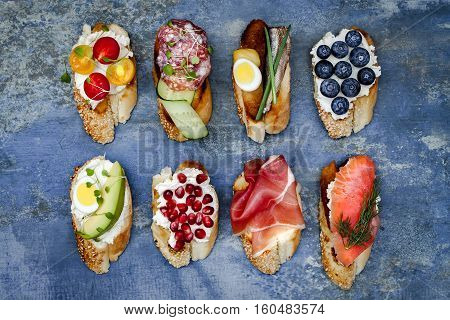 Mini sandwiches food set. Brushetta or authentic traditional spanish tapas for lunch table. Delicious snack appetizer antipasti on party or picnic time. Top view.