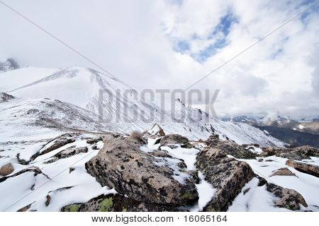 Snow and rocks on the mountain pass in Caucasus