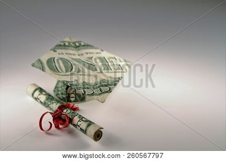 Graduation Cap And Diploma Made From A One Dollar Bill.