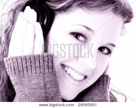  Beautiful sixteen year old teen girl listening to headphones. Shot in studio over white.