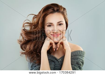 Smiling Woman with Red Curly Hair. Happy Redhead Model Pretty Face