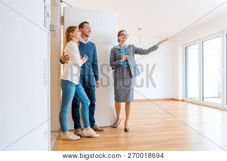 Realtor showing house to a young couple wanting to rent it