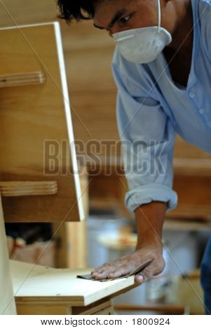 Worker Sanding With Sandpaper