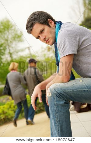 Young man and walking couple on a blurred background