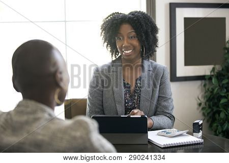 Black Female Businesswoman In An Office With A Client Giving Legal Advice About Taxes Or Financial L