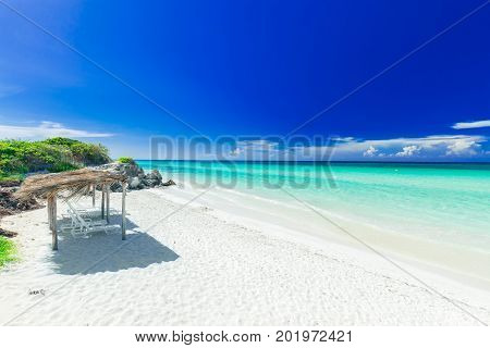 stunning, amazing inviting view of tropical white sand beach and tranquil turquoise ocean on dark deep, blue sky background at Cayo Coco Cuban island, sunny summer beautiful day