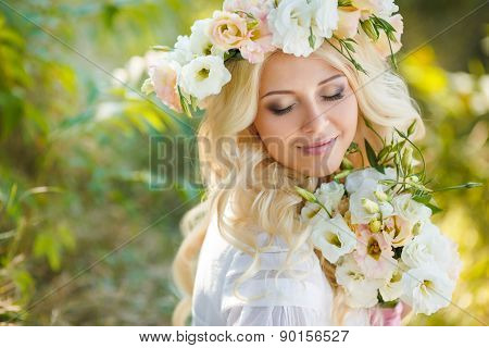 Portrait of a beautiful bride on floral swing in the Park.