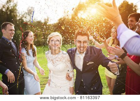 Newlyweds with guest on their garden party