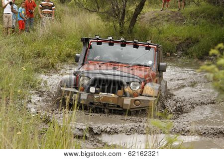 Crush Orange Jeep Rubicon Crossing Muddy Pond