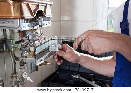 Handyman Adjusting Gas Water Heater