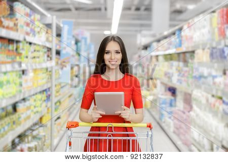 Happy Woman with Tablet Shopping  at The Supermarket