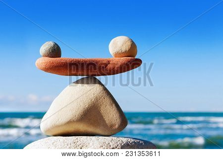 Concept Of Harmony And Balance. Balance Stones Against The Sea. Rock Zen In The Form Of Scales