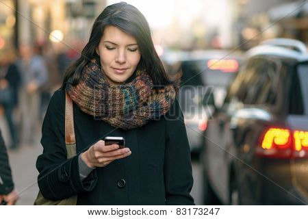 Fashionable Woman Busy With Phone At City Street