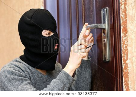 Burglar breaking into house