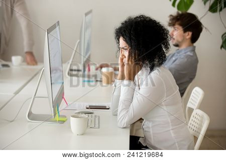 Stressed Young African American Businesswoman Suffering From Headache Migraine Touching Temples At W