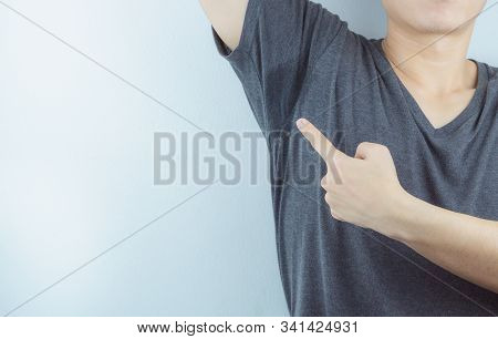 Closeup Man With Hyperhidrosis Sweating Very Badly Under Armpit And Left Stain On His Clothes. Healt