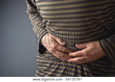 Abdominal Pain. Man Holds His Stomach And Has Hurt