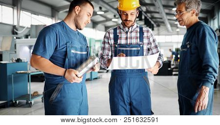 Engineer Teaching Apprentices To Use Computerized Cnc Metal Processing Machines In Factory