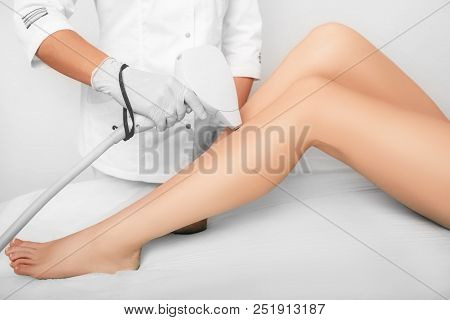 Beautician Removes Hair On Beautiful Female Legs Using A Laser. Hair Removal On The Legs, Laser Proc