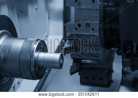 The Cnc Lathe Machine In Metal Working Process Cutting The Metal Shaft Parts With In The Light Blue 