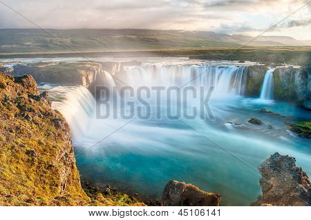 Godafoss is a very beautiful Icelandic waterfall. It is located on the North of the island not far from the lake Myvatn and the Ring Road. This photo is taken after the midnight sunset