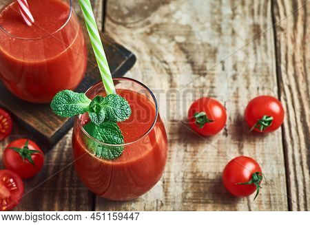 Fresh healthy red tomato juice served in glass  for diet and detox.Tomato juice detox. Red tomato juice detox diet. Diet tomato vegetable juice. Red tpmato juice. Red detox diet juice. Red vegie tomato juice detox.