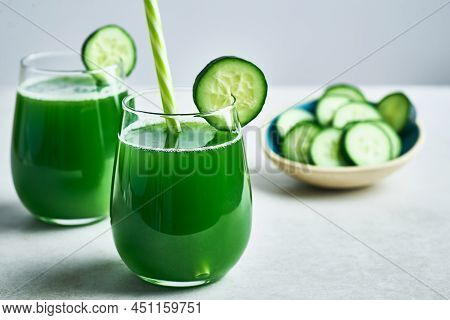 Fresh healthy green cucumber juice served in glass  for diet and detox.Cucumber juice detox. Green cucumber juice detox diet. Diet cucumber vegetable juice. Green Cucumber juice. Green detox diet juice. Green vegie cucumber juice detox.