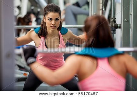 Athletic woman lifting a barbell