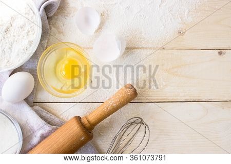 Eggs, Sugar, Flour, Whisk, Rolling Pin On Vintage Wooden Background. Cooking Dessert Flat Lay Top Vi