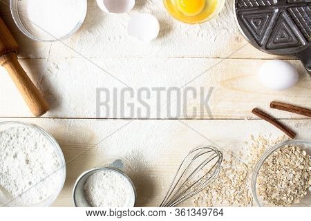 Eggs, Sugar, Flour, Oatmeal, Cinnamon, Whisk, Rolling Pin On Vintage Wooden Background. Cooking Dess