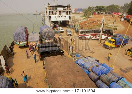 CHHOTA DHULANDI, BANGLADESH - FEBRUARY 19, 2014: Unidentified ferry staff and passengers present at unloading Daulatdia ferry boats at Ganga river bank in Chhota Dhulandi, Bangladesh. Ferry is a very important way of transportation in Bangladesh.