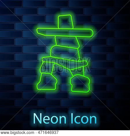 Glowing Neon Line Inukshuk Icon Isolated On Brick Wall Background. Vector