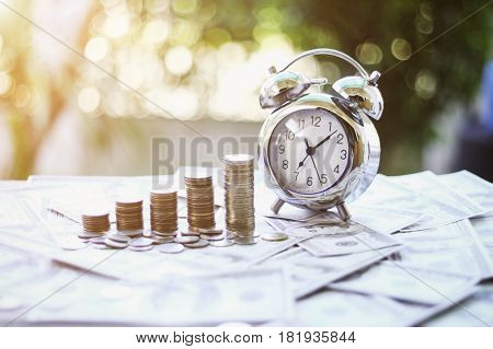 Close up of Business Finance and Money concept Save money for prepare in the future.time and money with green bokeh background e is money concept