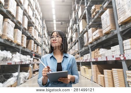 Candid Of Young Attractive Asian Woman Auditor Or Trainee Staff Work Looking Up Stocktaking Inventor