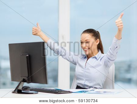 business, internet, office and technology concept - smiling businesswoman with computer and paper showing thumbs up