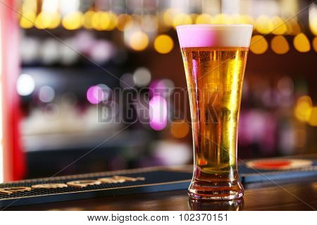 Cold beer glass on bar or pub desk