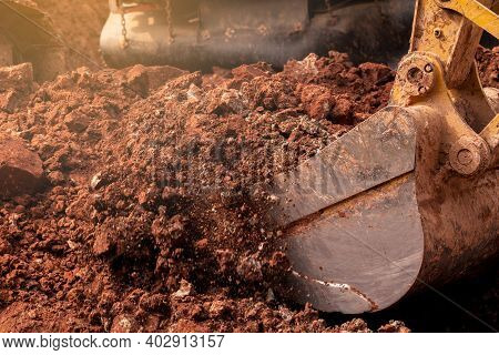 Closeup Bucket Of Backhoe Digging The Soil At Construction Site. Crawler Excavator Digging On Demoli