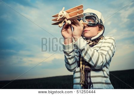 Little boy with wooden plane