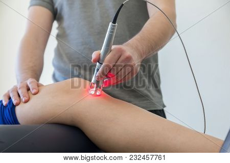 Laser Therapy On A Knee Used To Treat Pain. Selective Focus