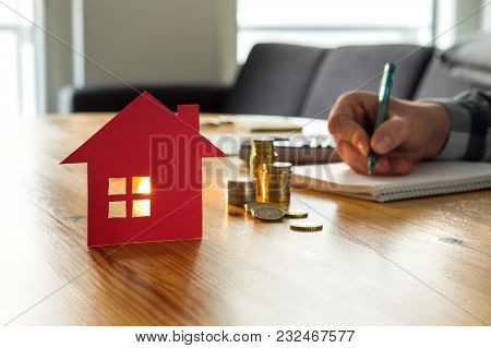 Man Counting House Price, Home Insurance Cost, Property Value Or Rent On Paper. Realtor Or Real Esta