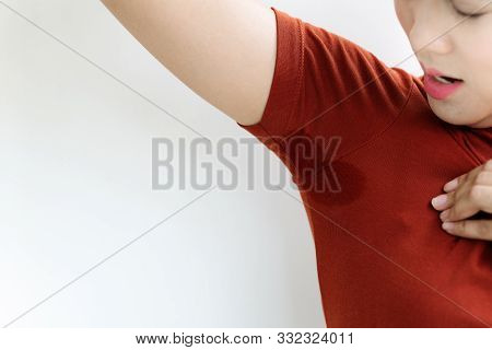 Woman With Hyperhidrosis Sweating. Young Asia Woman With Sweat Stain On Her Underarm Clothes. Health