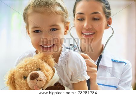 doctor examining a child in a hospital