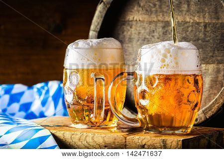 Beer. Oktoberfest.Two cold beers. Draft beer. Draft ale. Golden beer. Golden ale. Two gold beer with froth on top. Draft cold beer in glass jars in pub hotel or restaurant. Still life.