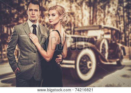 Beautiful retro couple against vintage car