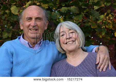 Mature couple in formal gardens.