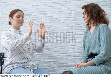 The Psychotherapist Conducts A Hypnosis Session. Female Patient Under Hypnosis.