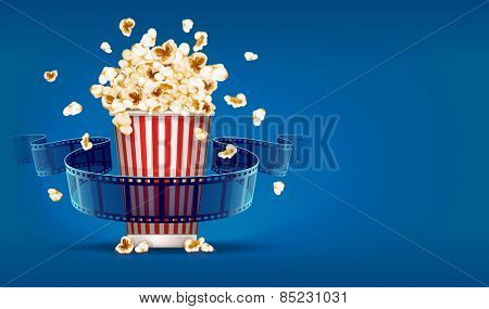 Popcorn for cinema and movie film tape on blue background. Eps10 vector illustration