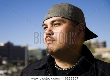 Portrait of a fashionable young man looking out at the city.